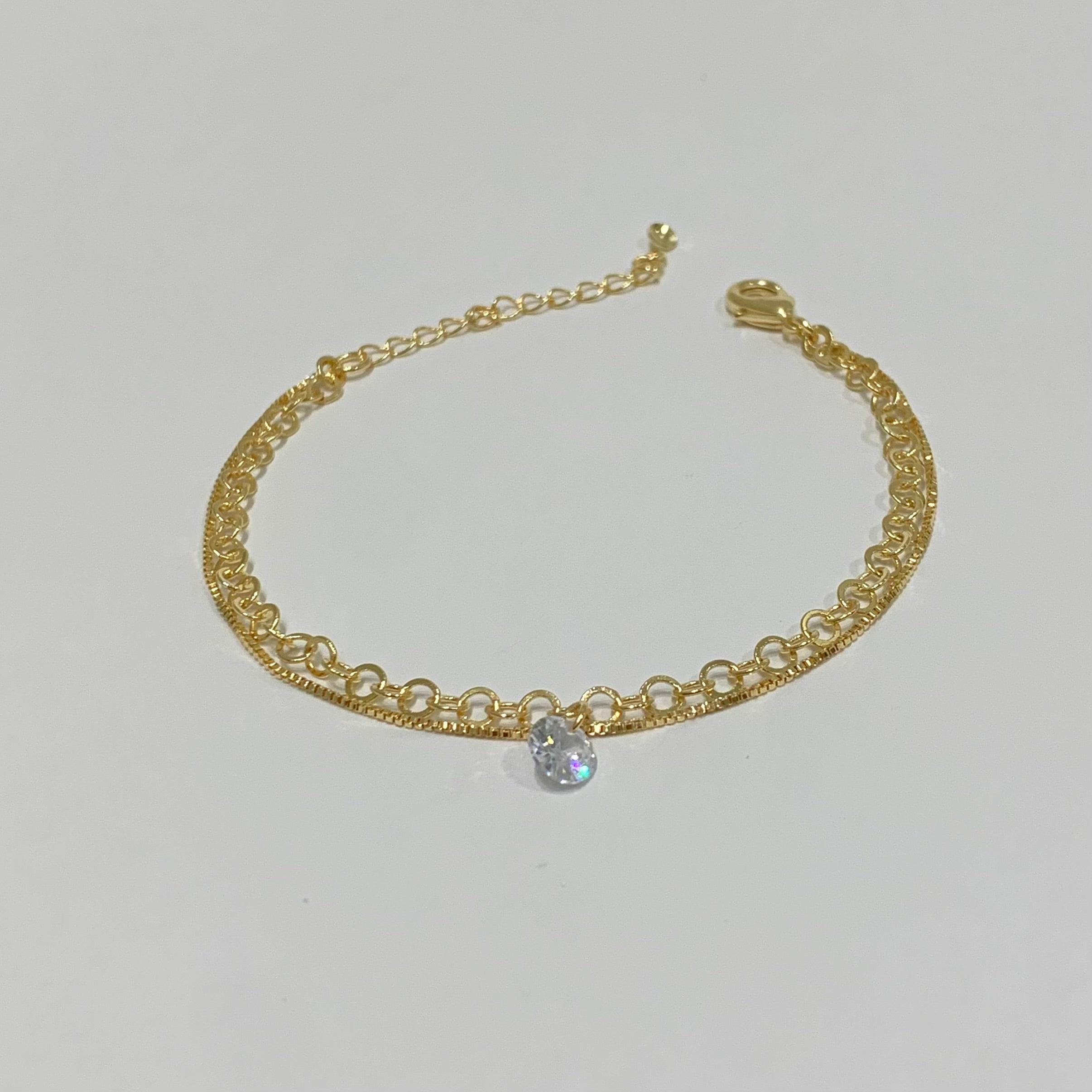 Pulseira dupla com ponto de zircônia folheado a ouro 18K